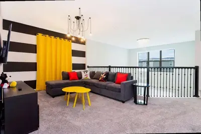 a living room with a couch and a table at Stunning Family Friendly 5 Bd w/ Pool Close to Disney @ Storey Lake 4242 in Kissimmee