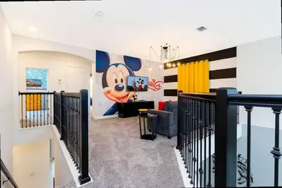 a room with a mickey mouse mural on the wall at Stunning Family Friendly 5 Bd w/ Pool Close to Disney @ Storey Lake 4242 in Kissimmee
