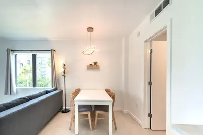 a living room with a table and a couch at Lovely Studio near Universal in Orlando
