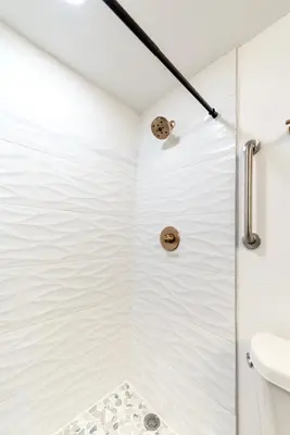 a white shower with a glass door in a bathroom at Lovely Studio near Universal in Orlando