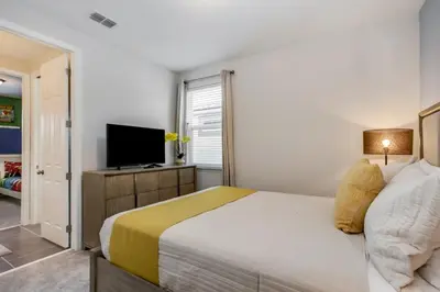 a bedroom with a bed and a flat screen tv at Darth's Manor 9 Bed 6 Bath Huge Home Solara Resort villa in Orlando