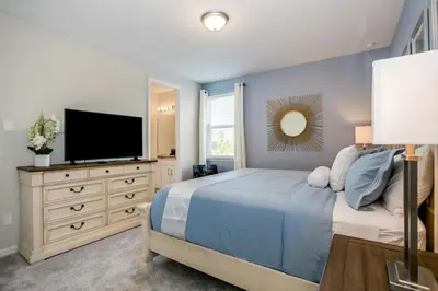 a bedroom with a bed and a flat screen tv at Darth's Manor 9 Bed 6 Bath Huge Home Solara Resort villa in Orlando