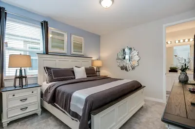 a bedroom with a large bed and a bathroom at Darth's Manor 9 Bed 6 Bath Huge Home Solara Resort villa in Orlando