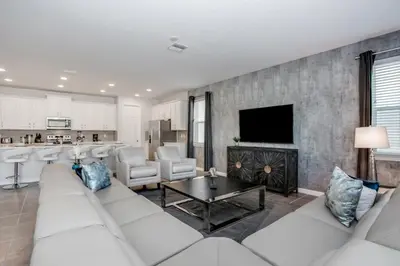 a living room with a white couch and a table at Darth's Manor 9 Bed 6 Bath Huge Home Solara Resort villa in Orlando