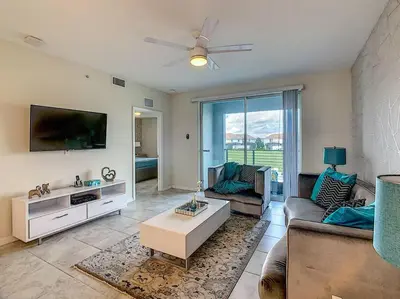 a living room with a couch and a tv at Last minute deal! Brand New 2bed apt near Disney in Kissimmee