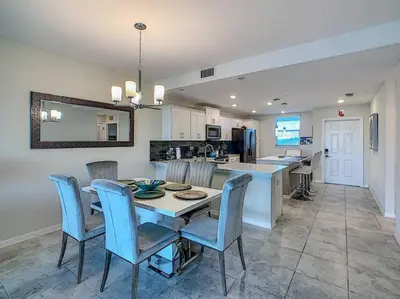 a kitchen and dining room with a table and chairs at Last minute deal! Brand New 2bed apt near Disney in Kissimmee