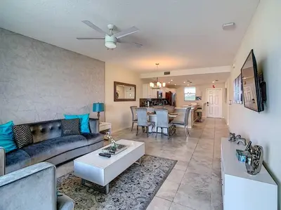 a living room with a couch and a table at Last minute deal! Brand New 2bed apt near Disney in Kissimmee