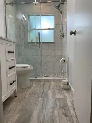 a bathroom with a shower and a toilet and a sink at Sanford Lake Mary Quiet Rooms in Sanford