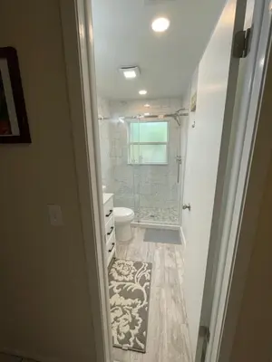 a bathroom with a shower and a toilet and a sink at Sanford Lake Mary Quiet Rooms in Sanford