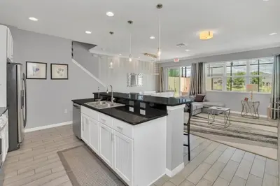 a kitchen with a sink and a counter top at 4 Bed townhome with Private Pool Near Disney! townhouse in Kissimmee
