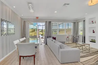 a living room with a couch and a table at 4 Bed townhome with Private Pool Near Disney! townhouse in Kissimmee