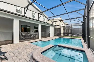 a swimming pool in a house with a glass ceiling at Monopoly Fun Storey Lake Resort 6 Bed Star Home! villa in Kissimmee