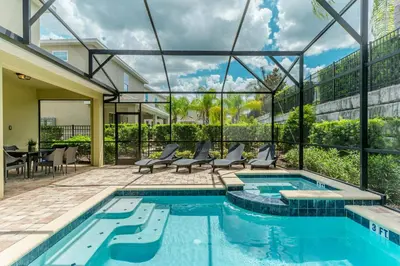 a swimming pool in a house with a glass wall at Encore Resort 5 Bedroom Home with Pool 2201 in Orlando