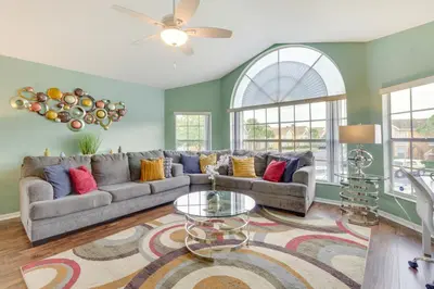 a living room with a couch and a table at Kissimmee Condo with Private Porch Less Than 7 Mi to Disney! in Kissimmee