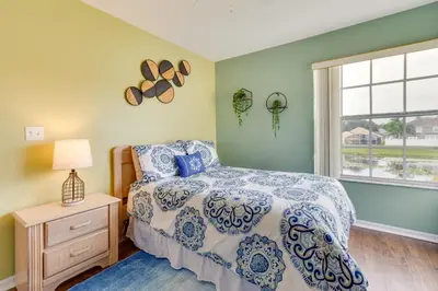 a bedroom with a bed and a window at Kissimmee Condo with Private Porch Less Than 7 Mi to Disney! in Kissimmee