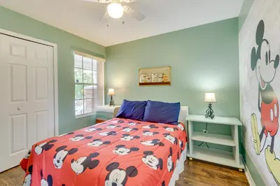a bedroom with a bed with a hello kitty comforter at Kissimmee Condo with Private Porch Less Than 7 Mi to Disney! in Kissimmee