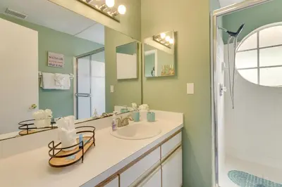 a bathroom with a sink and a mirror and a shower at Kissimmee Condo with Private Porch Less Than 7 Mi to Disney! in Kissimmee