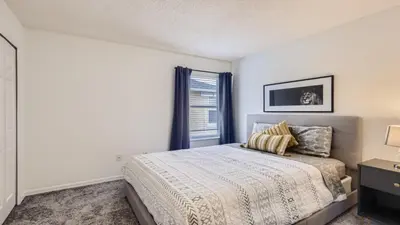 a bedroom with a bed and a window at Magical 7BR Resort Pool Home Near Disney & Orlando Attractions in Kissimmee