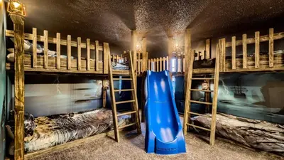 a room with two bunk beds and a blue slide at Magical 7BR Resort Pool Home Near Disney & Orlando Attractions in Kissimmee