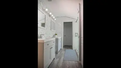 a white bathroom with a sink and a mirror at Family Home with Private Pool Yard Only 24 Mi to Disney in Saint Cloud