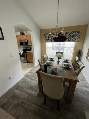 a dining room with a table and chairs at Family Oasis 5BR Villa with South Facing Pool and Games Room Near Disney in Kissimmee