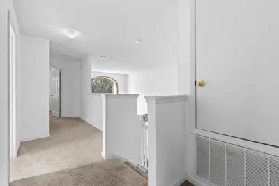 a hallway of a home with white walls at Family Oasis 5BR Villa with South Facing Pool and Games Room Near Disney in Kissimmee