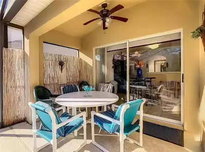 a dining room with a table and chairs and a ceiling fan at Family Oasis 5BR Villa with South Facing Pool and Games Room Near Disney in Kissimmee