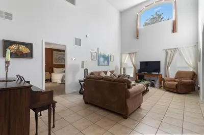 a living room with a couch and a piano at Family Oasis 5BR Villa with South Facing Pool and Games Room Near Disney in Kissimmee