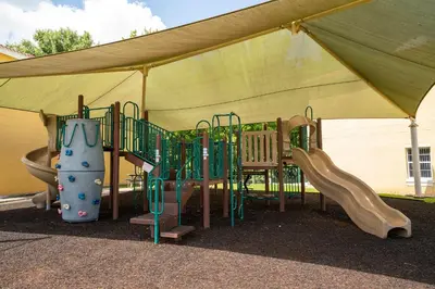 a playground under a tent with a slide at JC DISNEY House in Kissimmee