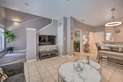 a living room with a couch and a table at 9 Mi to Disney Resort Getaway with Private Patio! in Kissimmee