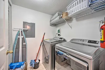 a laundry room with a washer and dryer at 9 Mi to Disney Resort Getaway with Private Patio! in Kissimmee