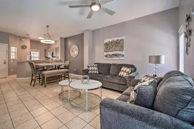 a living room with a couch and a table at 9 Mi to Disney Resort Getaway with Private Patio! in Kissimmee