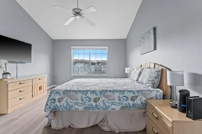 a bedroom with a bed and a ceiling fan at Poinciana Paradise in Kissimmee