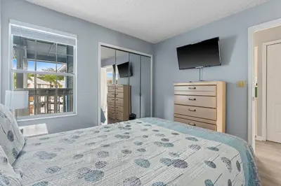 a bedroom with a bed and a flat screen tv at Poinciana Paradise in Kissimmee