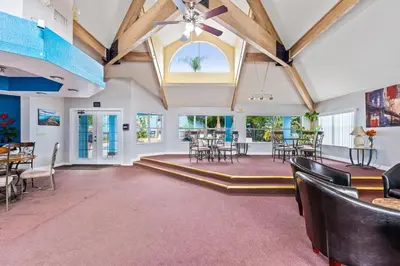 a large room with tables and chairs and a vaulted ceilings at Poinciana Paradise in Kissimmee