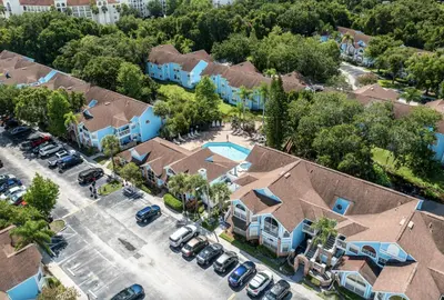 an aerial view of a community of houses with a parking lot at Poinciana Paradise in Kissimmee