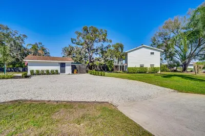 a house with a driveway in front of a house at Lakefront Retreat with Kayaks and Fire Pit in Clermont in Clermont