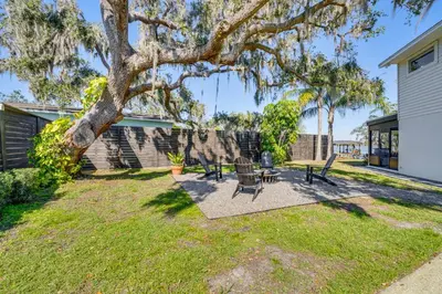 a yard with picnic tables and a tree at Lakefront Retreat with Kayaks and Fire Pit in Clermont in Clermont