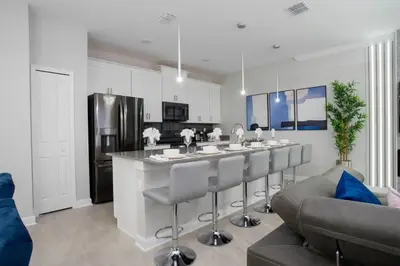 a kitchen with a large island in a living room at Gorgeous 4Bd w/ Pool Close to Disney @ Storey Lake 4289 in Kissimmee