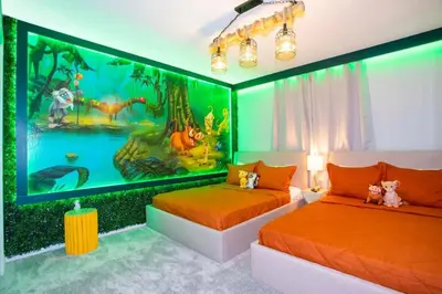 a bedroom with two beds with a mural of dinosaurs at Gorgeous 4Bd w/ Pool Close to Disney @ Storey Lake 4289 in Kissimmee