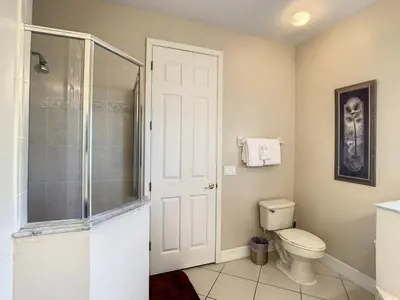 a bathroom with a toilet and a glass shower at Fantastic 7 Bed 6 Bath in Prestigious Gated Comm, villa in Orlando