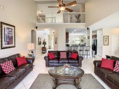 a living room with leather couches and a table at Fantastic 7 Bed 6 Bath in Prestigious Gated Comm, villa in Orlando