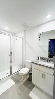 a bathroom with a toilet and a shower and a sink at NEW! Solara Pool Home 6 Miles to Disney in Kissimmee