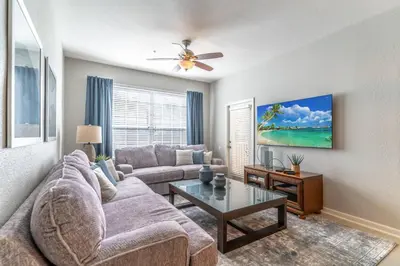a living room with a couch and a table at 2788 Windsor Hills in Orlando