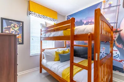 a bedroom with bunk beds with yellow and blue at 2788 Windsor Hills in Orlando