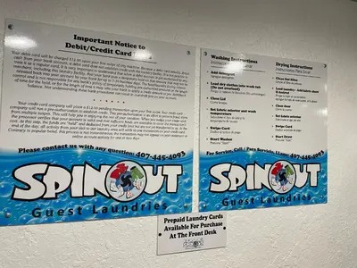 two signs hanging on a wall with a sign for a gym at Lovely 1 bedroom Condo with pool in Orlando