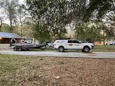 a truck and a boat hooked up to a boat trailer at The Piano House in Orlando
