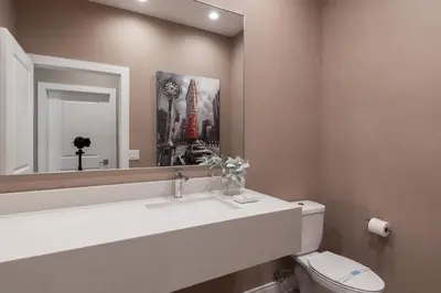 a bathroom with a sink and a mirror and a toilet at Cozy Home Resort Community Disney 5 Min in Orlando