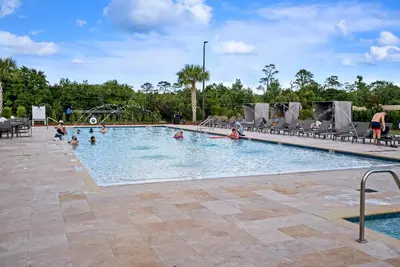 a pool with people playing in the water at Cozy Home Resort Community Disney 5 Min in Orlando