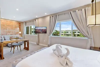a bedroom with a large bed and a living room at Cozy Home Resort Community Disney 5 Min in Orlando
